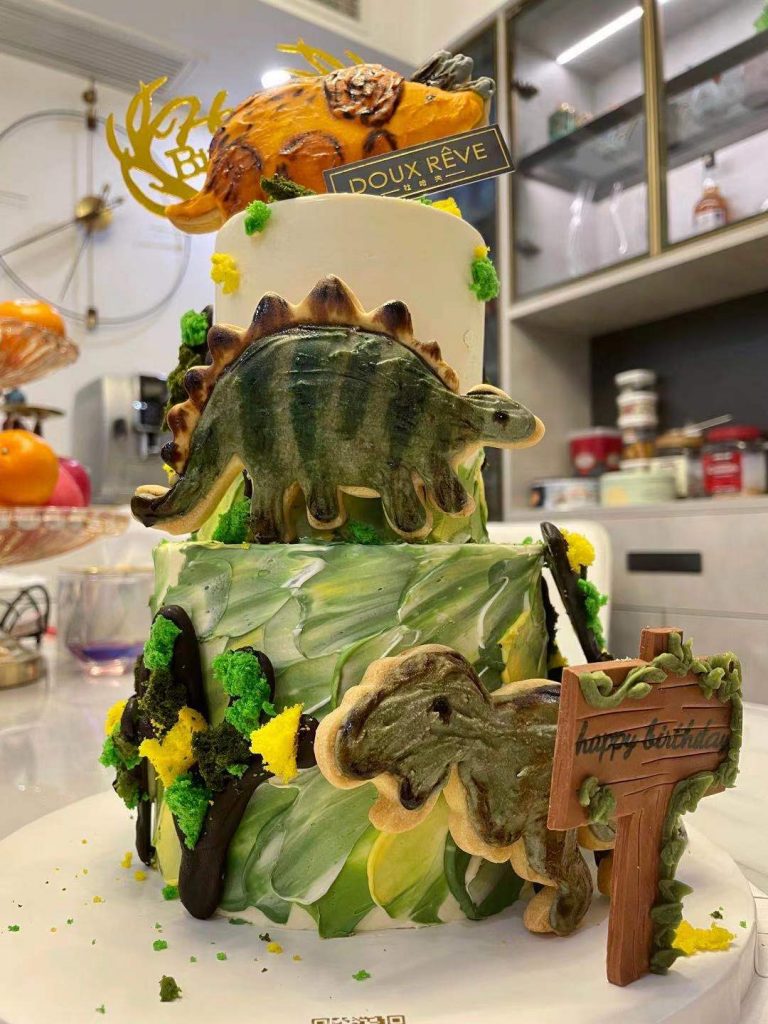He loves the dinosaur birthday cake!