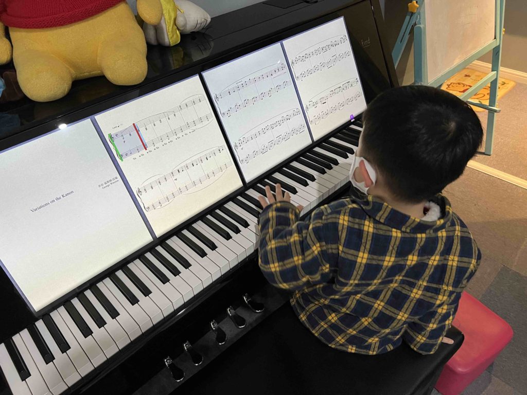 Lucas playing the piano. Really just playing it like a toy kind of playing...