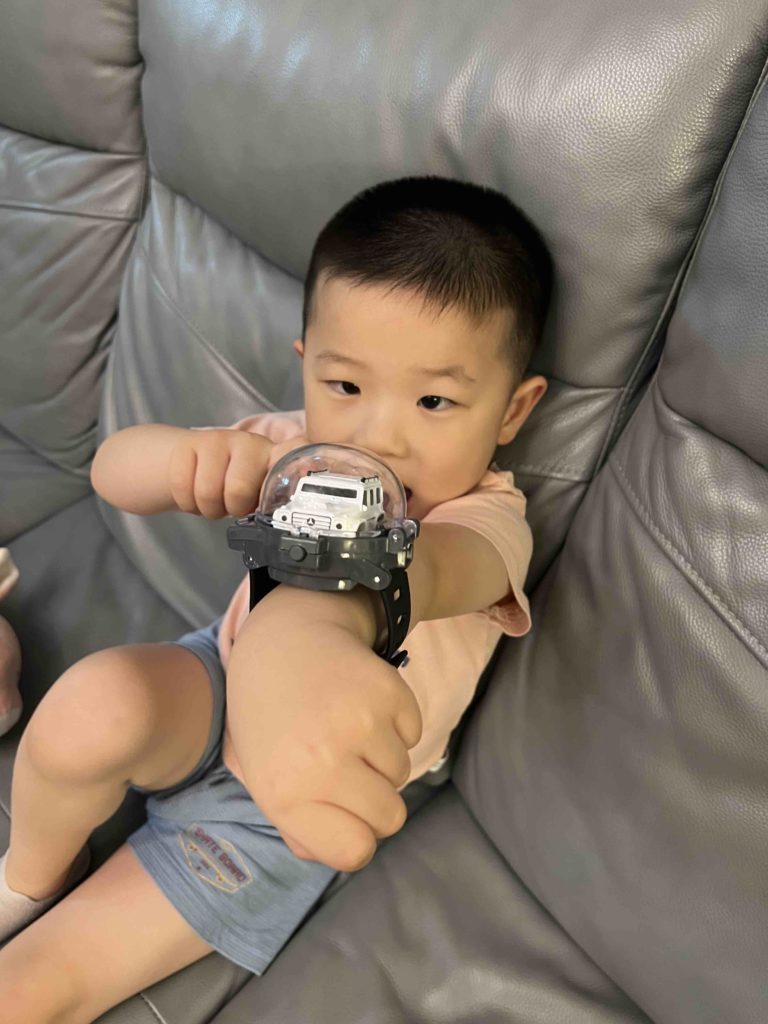 Loving his remote controlled watch!