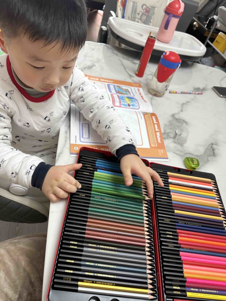 Loving his colour pencils; Christmas present from Santa Claus!