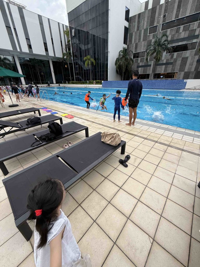 Watching Big Bro jump into the pool. Big bro is extra brave when showing little sis.