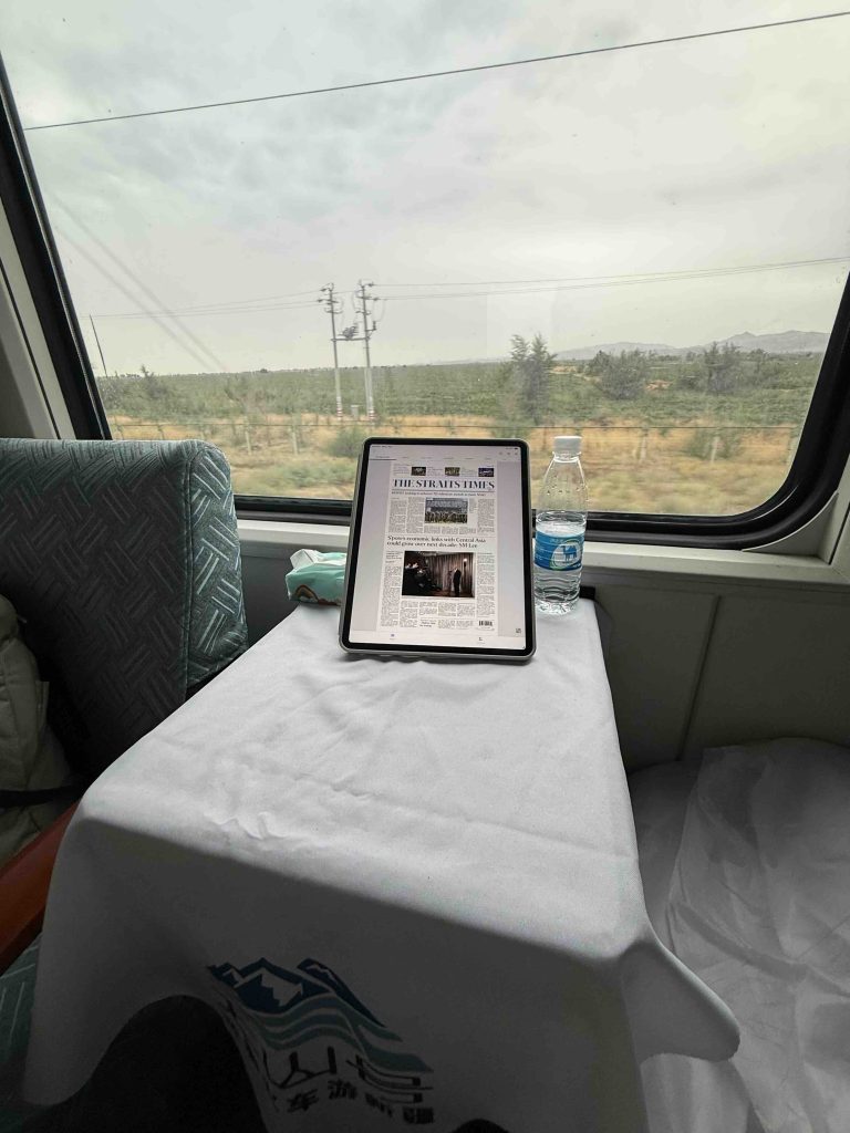 Reading the newspaper while on the way in the train.