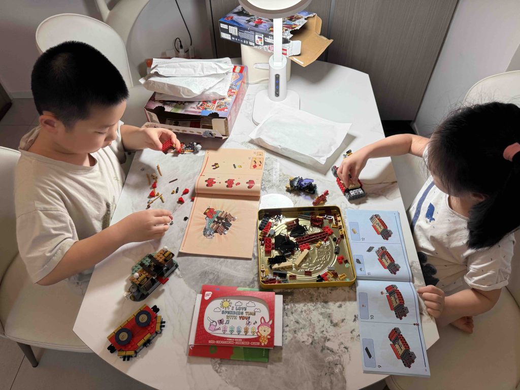 Enjoying their Childrens' day celebration unboxing their lego...